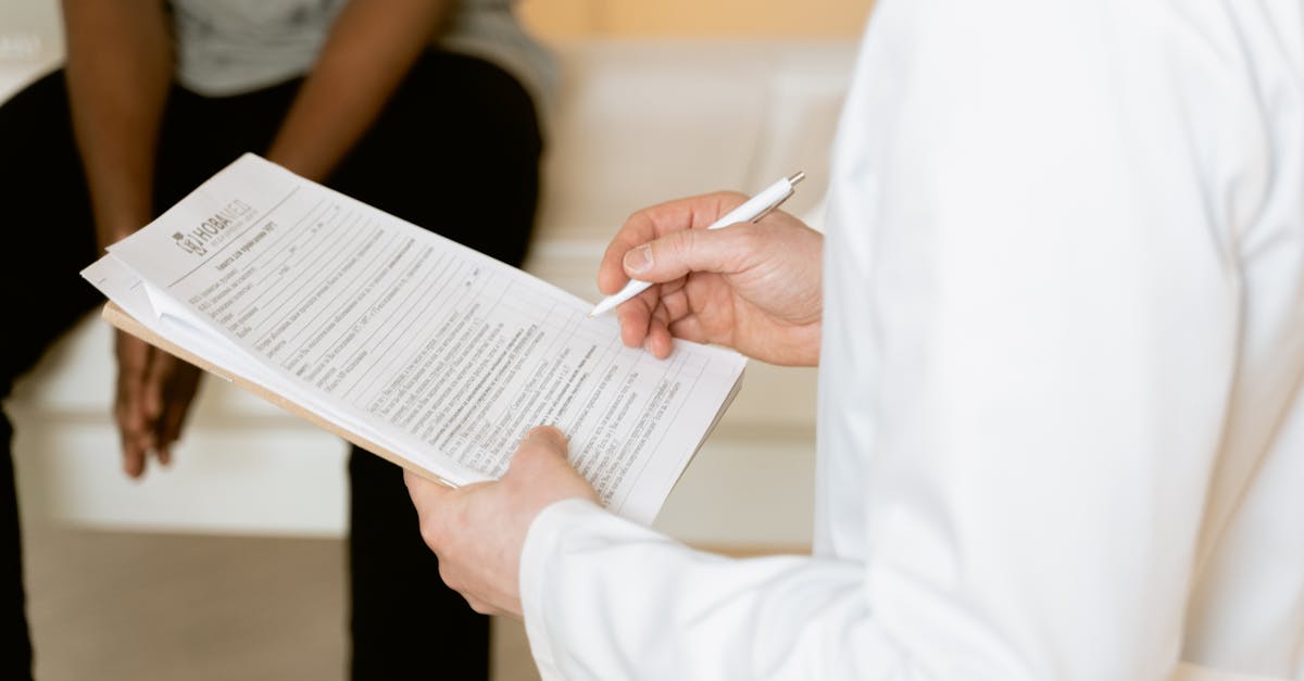 Healthcare professional reviews medical form during patient consultation in a clinic setting.